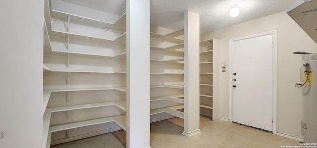 storage area featuring electric water heater