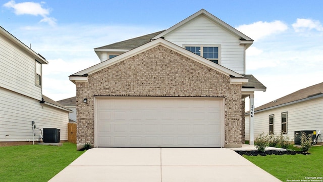 view of front of property featuring brick siding, central AC unit, concrete driveway, an attached garage, and a front yard