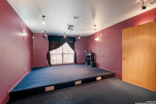 interior space featuring dark carpet and visible vents