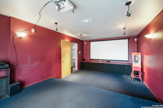 cinema with carpet floors, visible vents, and baseboards