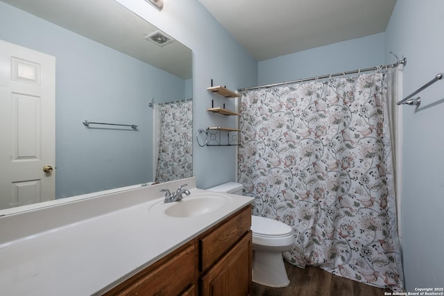 full bathroom with toilet, wood finished floors, visible vents, vanity, and a shower with curtain