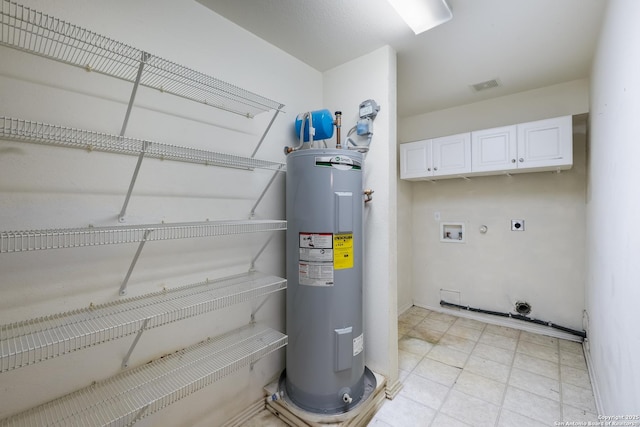 utility room featuring water heater and visible vents