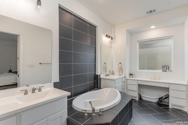 full bathroom with visible vents, a sink, a garden tub, tile patterned flooring, and two vanities