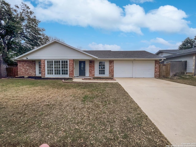 ranch-style house with concrete driveway, brick siding, and a front lawn