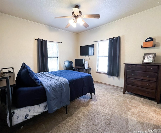 bedroom featuring a textured ceiling, ornamental molding, a ceiling fan, and light colored carpet