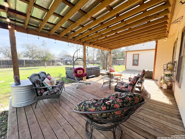 wooden terrace with a hot tub, an outdoor living space, a fenced backyard, and a yard