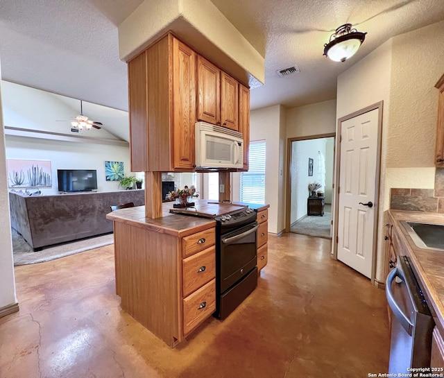 kitchen featuring dark countertops, black electric range oven, white microwave, open floor plan, and concrete flooring