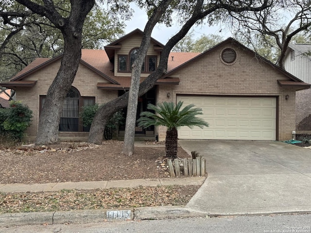 view of front of house featuring driveway, brick siding, and an attached garage