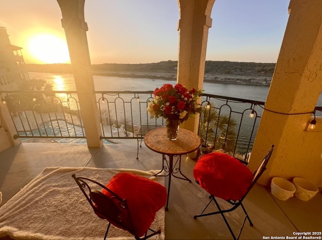 balcony at dusk with a water view