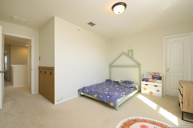 bedroom featuring light carpet and visible vents