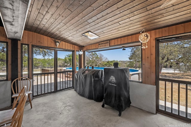 sunroom / solarium featuring wooden ceiling and vaulted ceiling