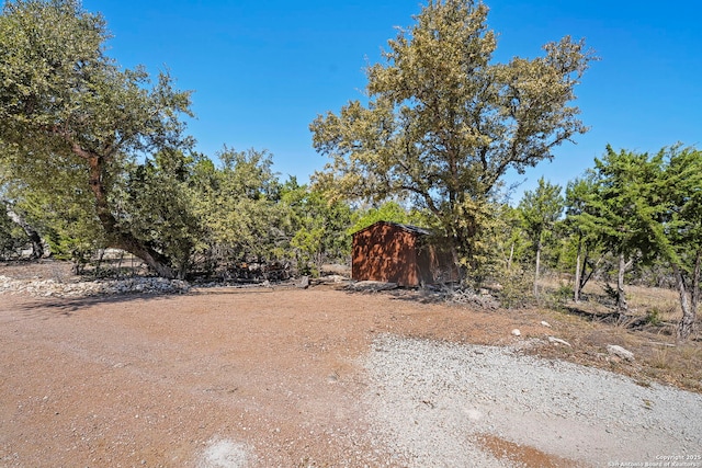 view of yard featuring an outbuilding and a storage shed