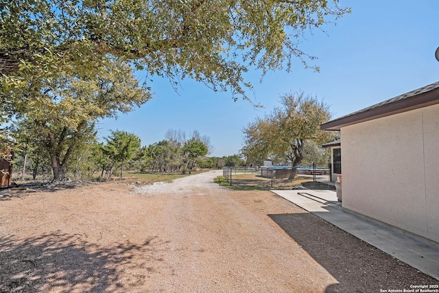 view of road with a gated entry and driveway