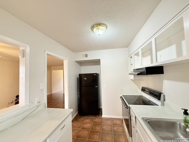 kitchen with freestanding refrigerator, white cabinetry, a sink, range with electric cooktop, and under cabinet range hood