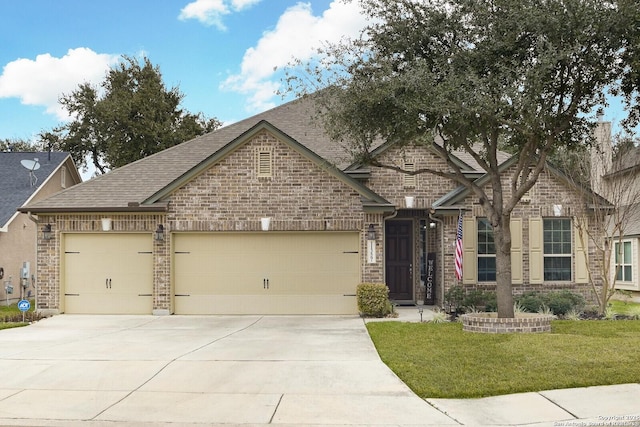 view of front of property with an attached garage, brick siding, a shingled roof, concrete driveway, and a front yard