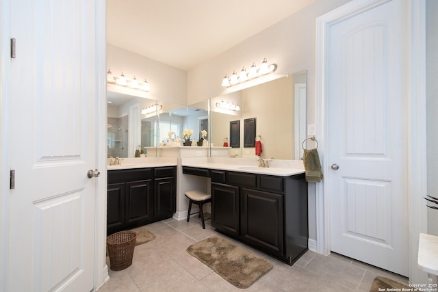 full bathroom with two vanities, a sink, and tile patterned flooring