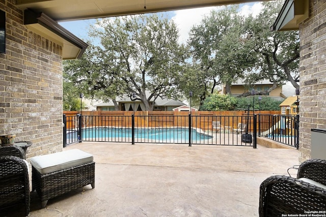 view of patio / terrace with a fenced backyard and a fenced in pool