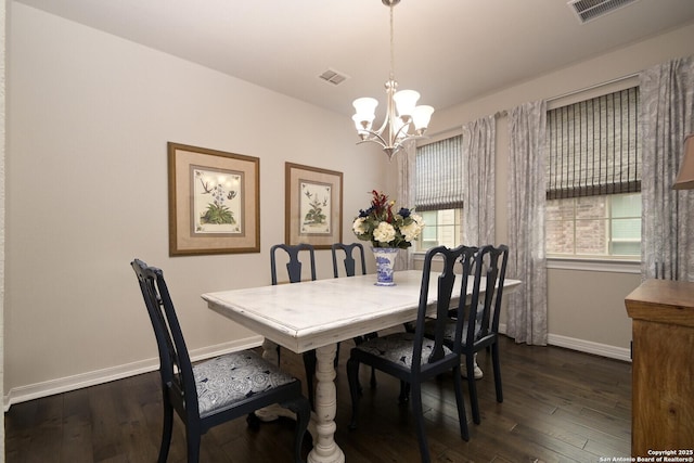 dining room with dark wood-style floors, visible vents, and baseboards