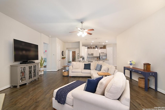 living room featuring baseboards, dark wood finished floors, and a ceiling fan