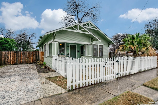 bungalow featuring covered porch and a fenced front yard