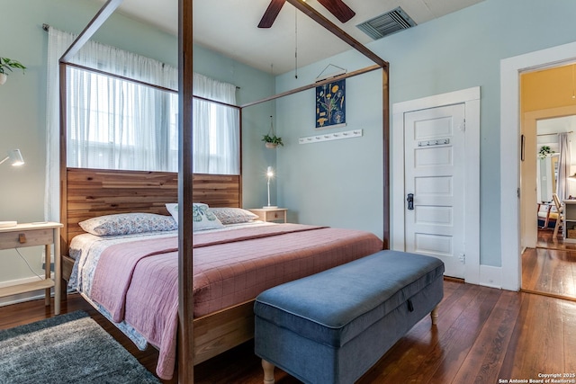 bedroom with baseboards, ceiling fan, visible vents, and dark wood-style flooring