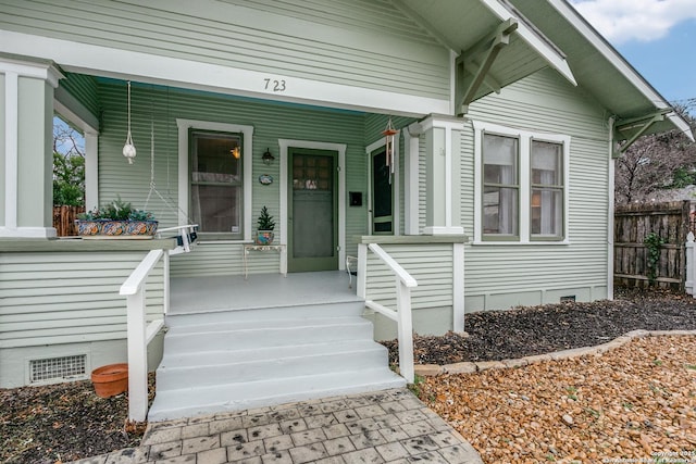 property entrance featuring covered porch, crawl space, and visible vents