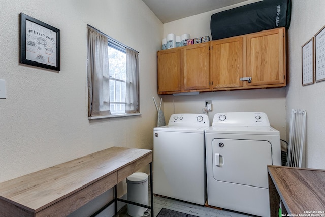 washroom with washer and dryer and cabinet space