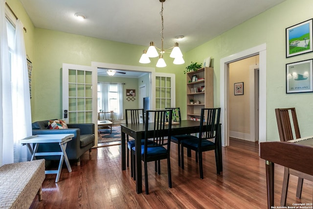 dining room featuring wood finished floors and ceiling fan with notable chandelier