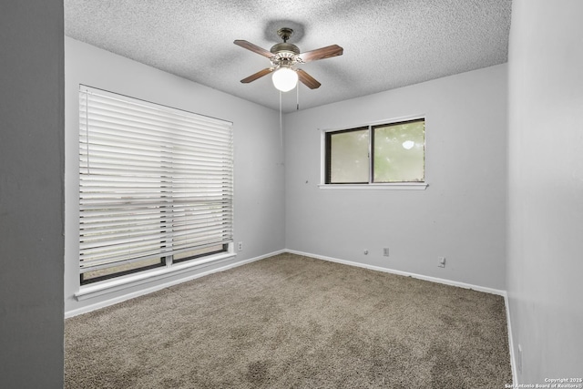carpeted empty room featuring a ceiling fan, a textured ceiling, and baseboards