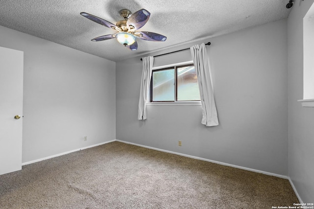 spare room with a textured ceiling, carpet flooring, a ceiling fan, and baseboards