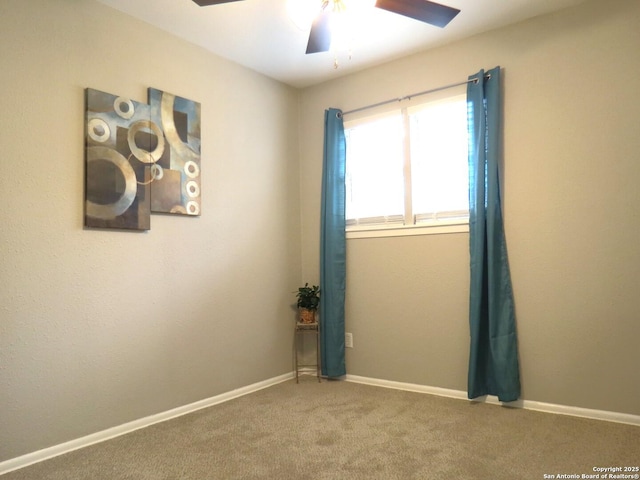 unfurnished room featuring carpet, a ceiling fan, and baseboards