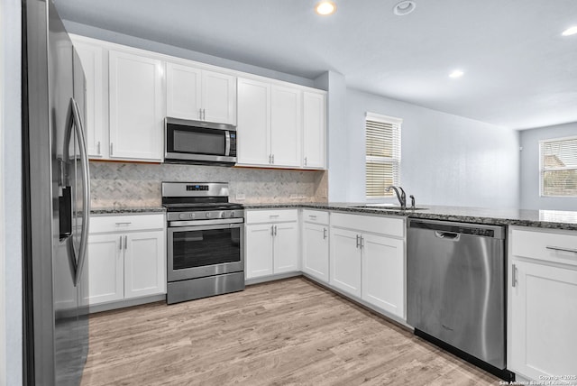 kitchen with white cabinetry, appliances with stainless steel finishes, and a sink