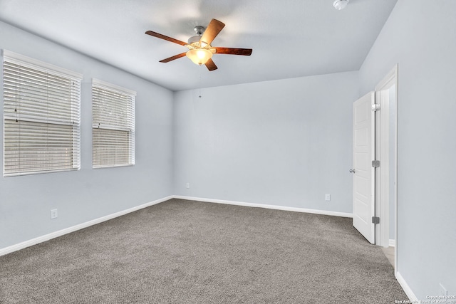 spare room featuring carpet flooring, ceiling fan, and baseboards