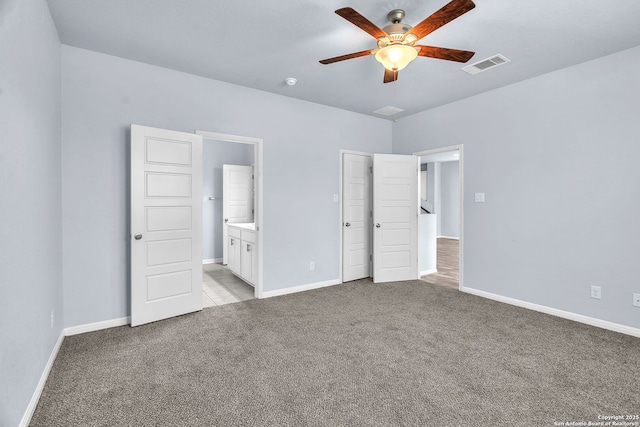 unfurnished bedroom featuring baseboards, visible vents, and light colored carpet