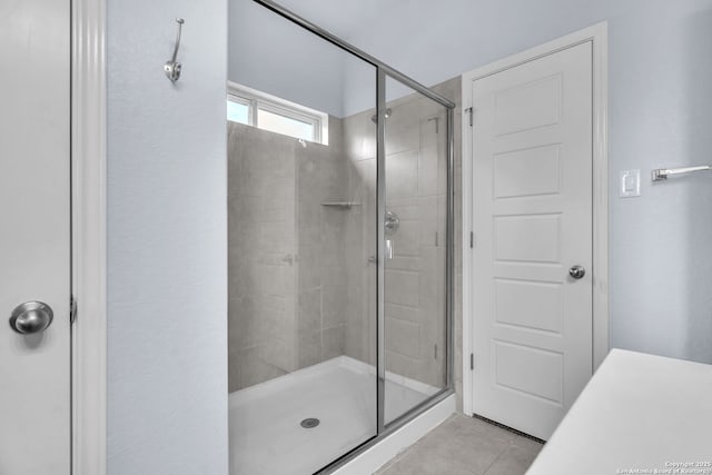 full bathroom with a shower stall and tile patterned floors