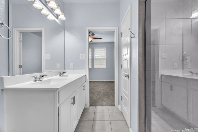 bathroom featuring a ceiling fan, tile patterned flooring, a sink, and double vanity