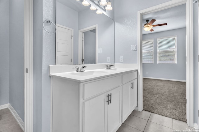 full bath with double vanity, tile patterned flooring, ceiling fan, and a sink