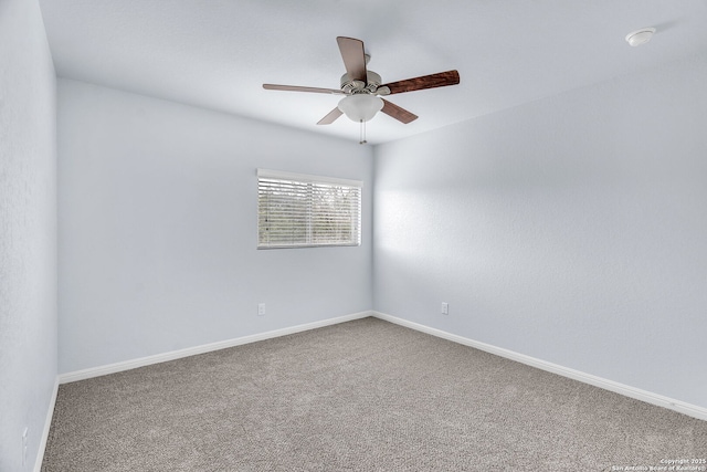 empty room featuring carpet, a ceiling fan, and baseboards