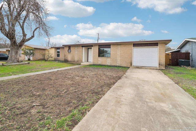 single story home featuring an attached garage, brick siding, fence, concrete driveway, and a front yard