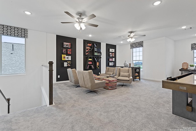 living room featuring light colored carpet, visible vents, baseboards, and recessed lighting