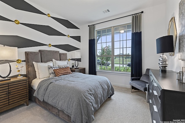 bedroom with light colored carpet, visible vents, vaulted ceiling, and baseboards