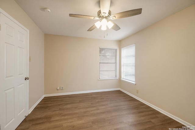 unfurnished room with ceiling fan, wood finished floors, and baseboards