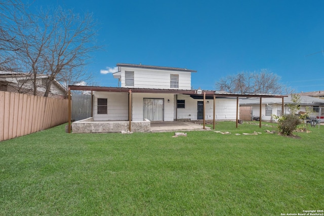 rear view of house featuring a fenced backyard, a lawn, and a patio