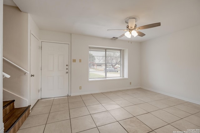 entryway with ceiling fan, stairway, light tile patterned flooring, and baseboards