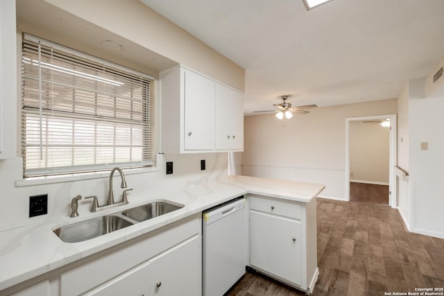 kitchen featuring dishwasher, light countertops, and white cabinetry