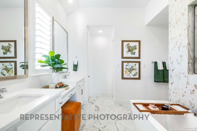 11717 Warlock, San Antonio, TX 78254 - bathroom featuring a freestanding bath, double vanity, marble finish floors, vaulted ceiling, and recessed lighting
