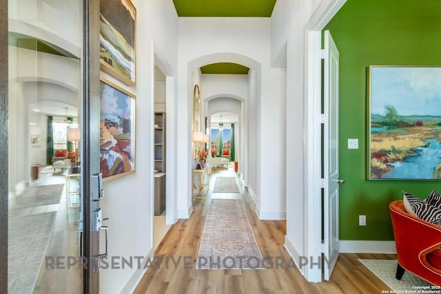 11717 Warlock, San Antonio, TX 78254 - hall with arched walkways and light wood-type flooring