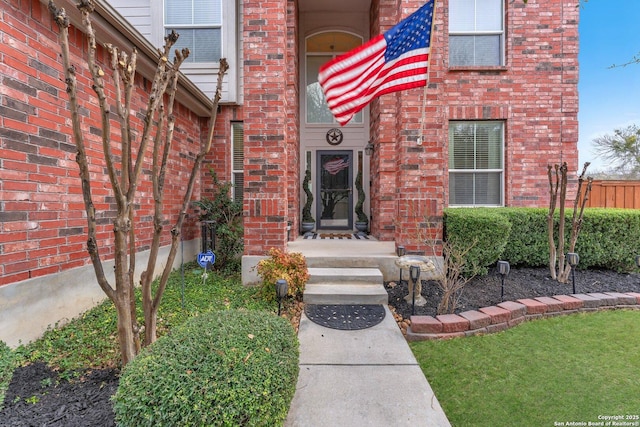 doorway to property with brick siding