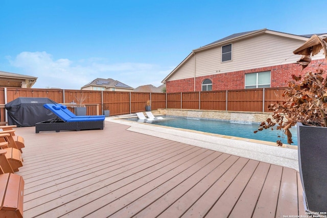 wooden terrace with fence and a fenced in pool