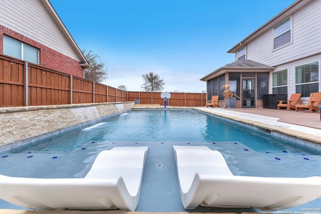 view of pool featuring a sunroom, a fenced backyard, a patio area, and a fenced in pool